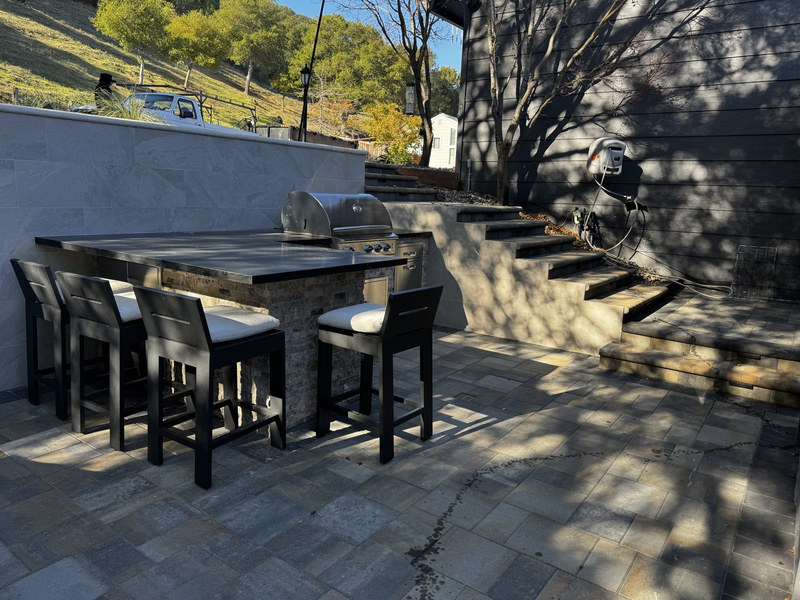 Stone-clad outdoor kitchen with built-in grill